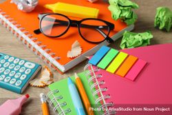 Close up of colorful stationary on wooden desk bGVze4