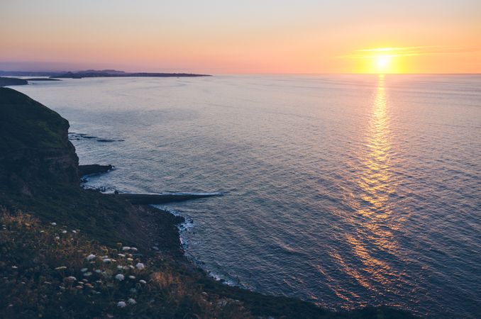 Sun setting over sea