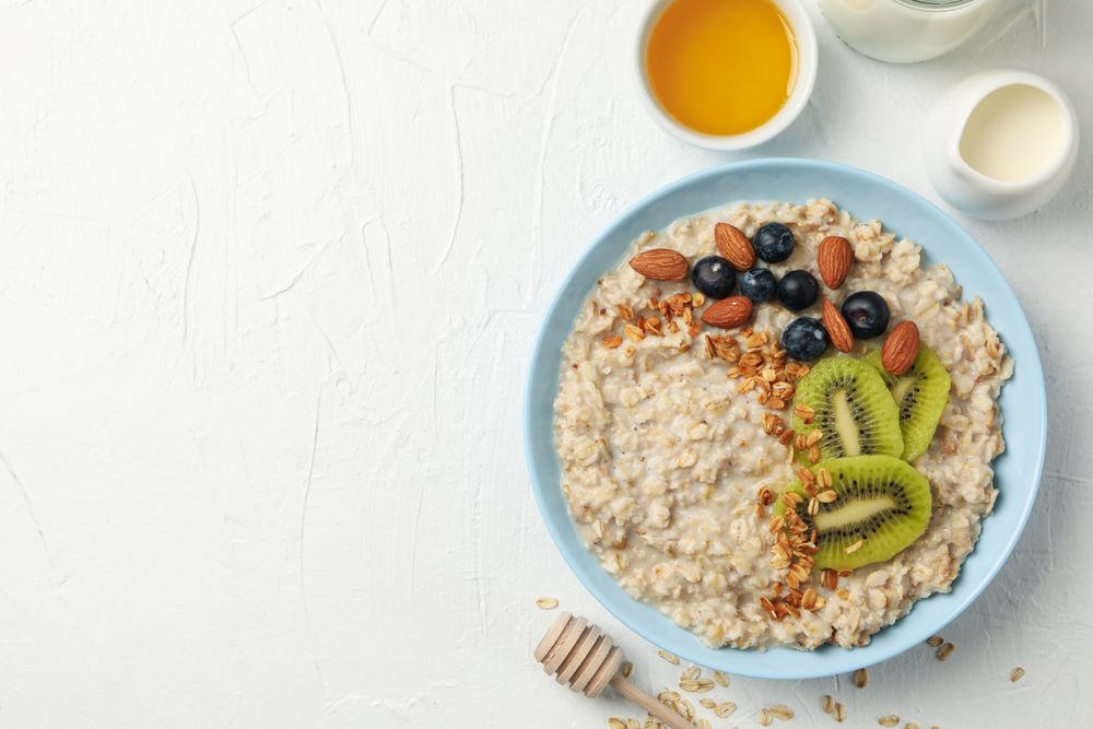 Composition with oatmeal with fruits on blank background