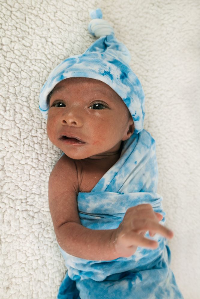 Newborn baby wrapped on soft blanket