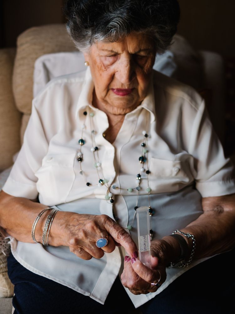 Mature woman taking pills at home
