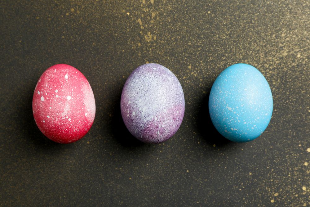 Decorated eggs on golden background. Top view