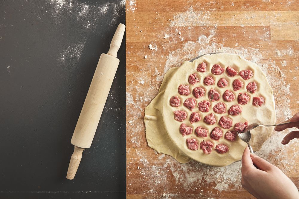 Ravioli filling being inserted into pasta dough