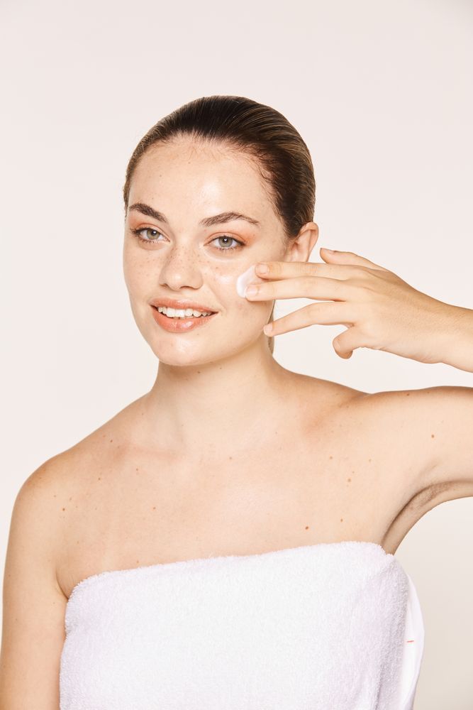 Amiable female taking care of face