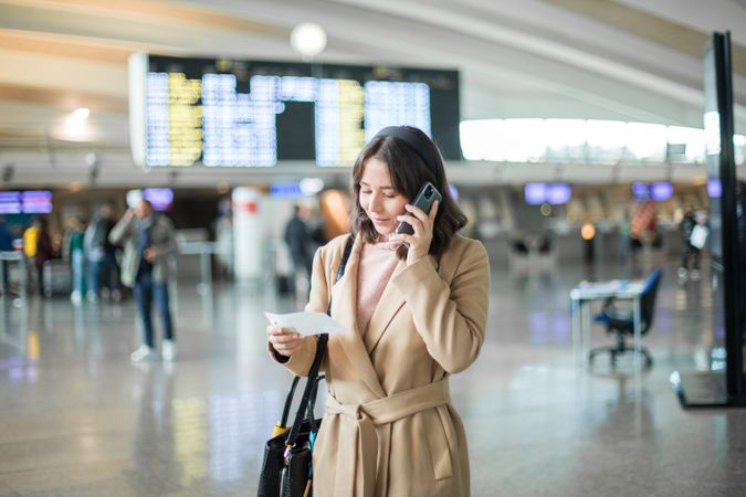 Woman using smartphone at airport