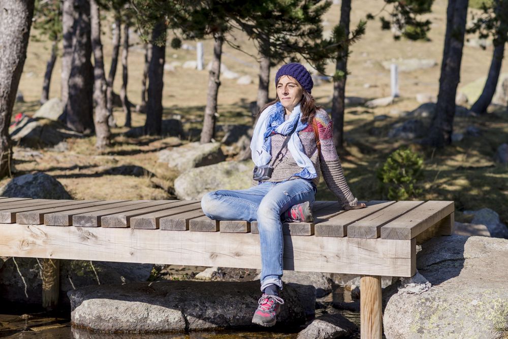 Woman sitting back on small pier over water