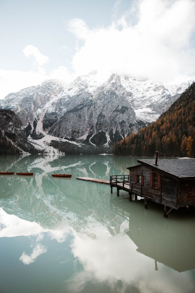 House on stilts on lake near mountains