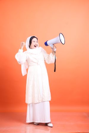 Empowered muslim announcing with megaphone, sharing enthusiasm