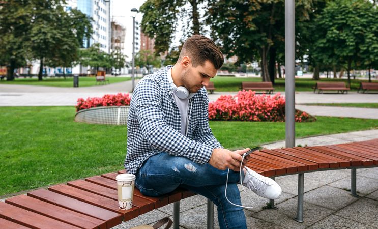 Young man using tablet outdoors