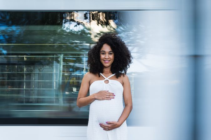 Smiling pregnant woman in long dress
