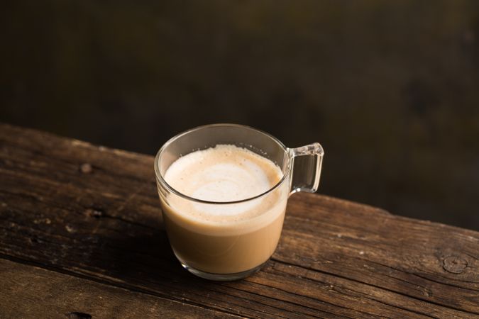 Cups of tasty hot coffee drink on wooden table