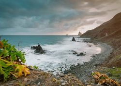 Lonely cliff in sea on cloudy day