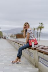 Young woman looking over sunglasses