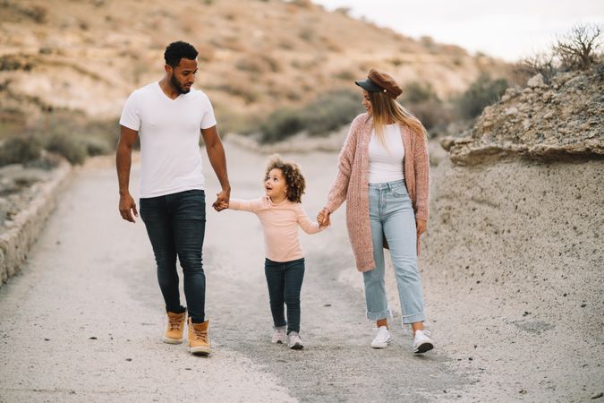 Stylish multiethnic family walking on nature