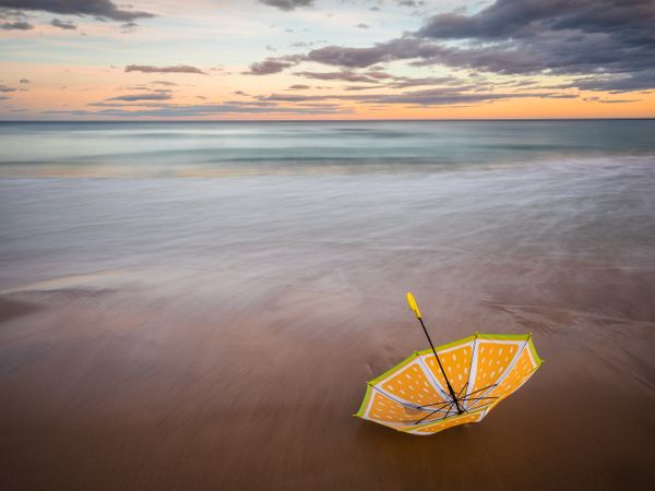 Umbrella on beach near sea