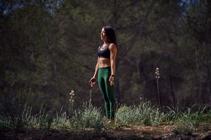 Fit woman standing in Tadasana pose during yoga practice