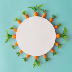 Creative composition made with carrots and paper card copy space