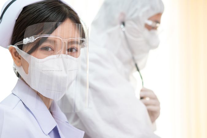 Female Asian nurse in protective mask and face shield in hospital