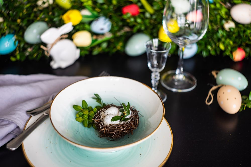 Delicate decorative nest in bowl on Easter table setting