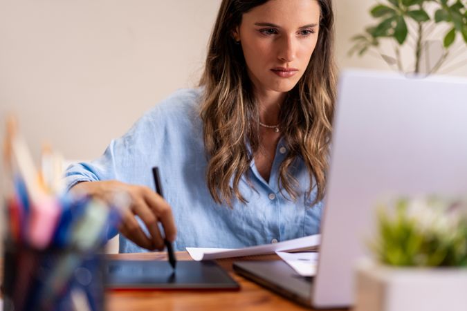 Professional Woman Using Digital Tablet in Home Office - Focused Remote Work