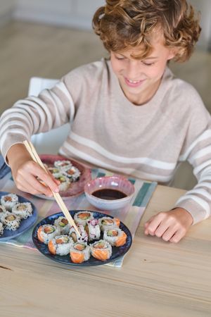Positive kid eating rolls at home