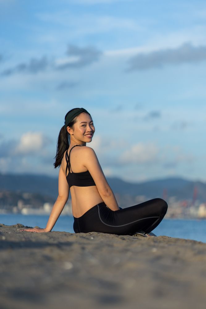 Sportive woman sitting in the on beach