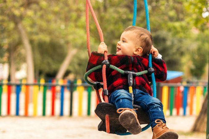 cute baby having fun in a swing