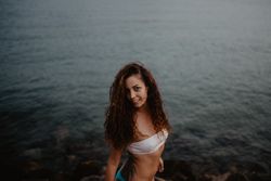 Smiling female standing near sea