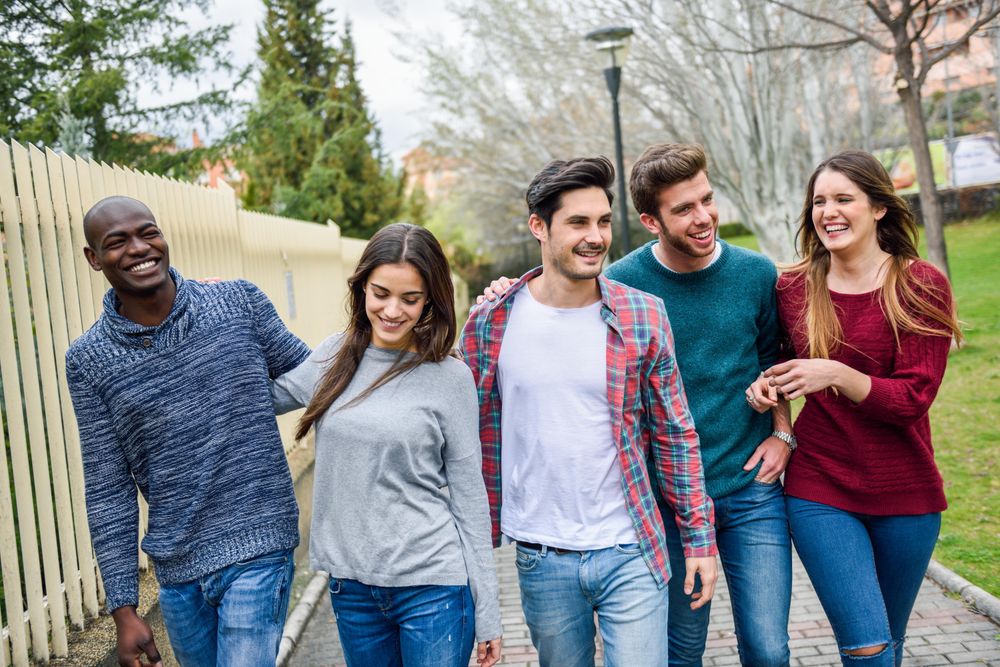 Smiling friends going for a stroll outside