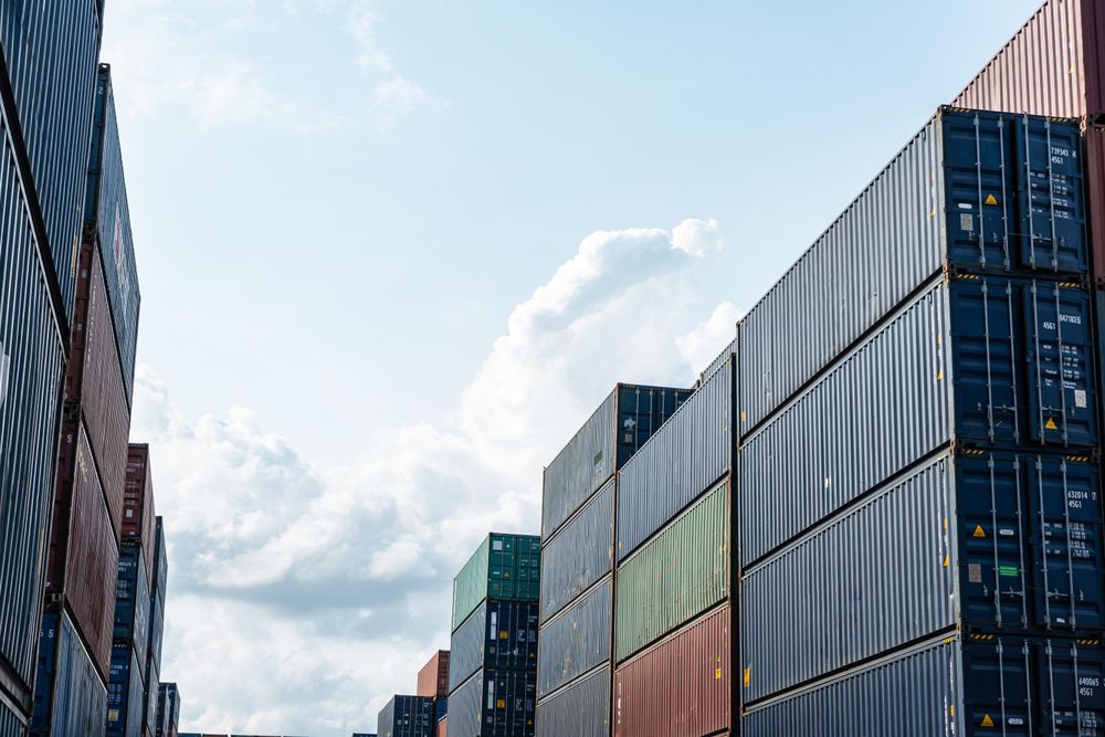 Container boxes stacked for freight cargo shipping looking up to sky