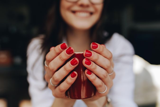Close up of woman hands holding a coffee cup