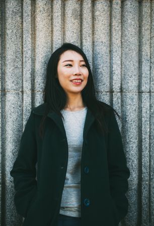 Asian woman near marble wall