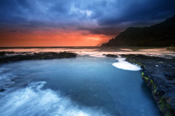 Amazing stone shore and pink sky with clouds