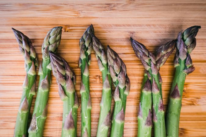 A bunch of green asparagus on wooden surface