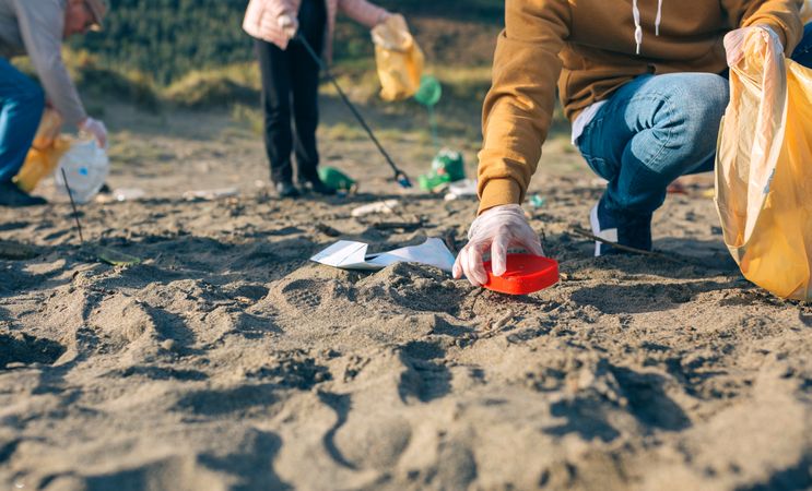 Young man cleaning the beach