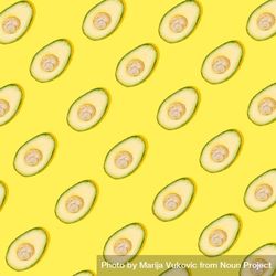 Cut avocado pattern on yellow background 4ZBDN4