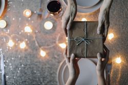 Birdseye view of hands passing a gift