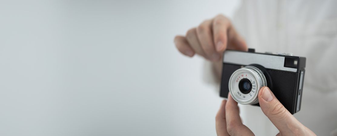 Young man holding retro camera