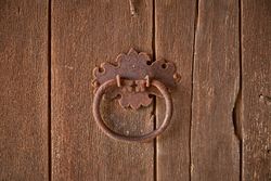 Metal old handle on wooden door
