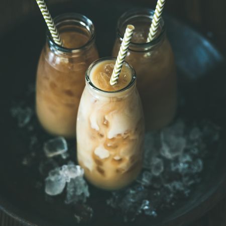 Thai iced tea in glass bottles with eco-friendly straws