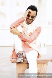 Man wearing kurta smiling and sitting outdoor 5n3d24