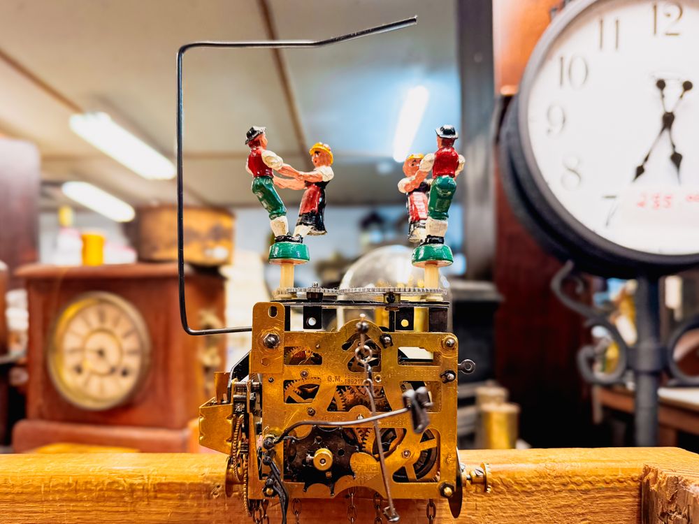 Cuckoo clock mechanism with dancing couple figurines in Alpine folk costumes