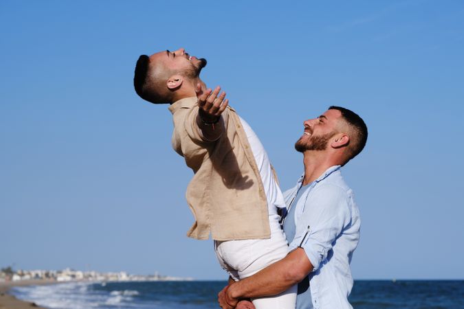 Happy gay couple enjoying and embracing outdoors