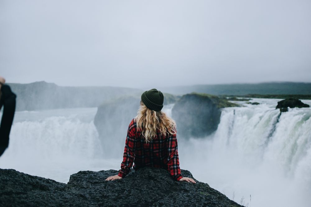 Back of woman overlooking waterfall