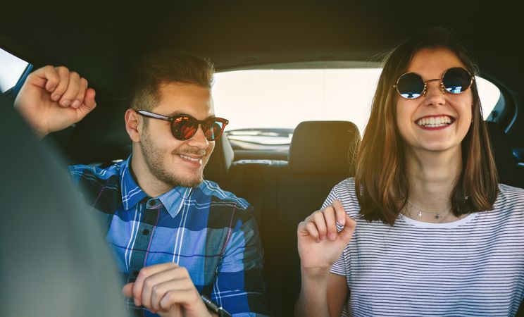 Young couple dancing in the car