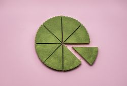 Whole matcha cheesecake sliced and ready to serve