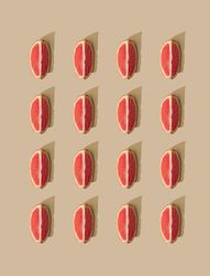 Pattern of grapefruit slices and pastel sand background
