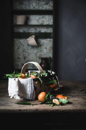 Mandarins and basket on table