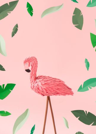 Pink flamingos on pink background, with green leaves