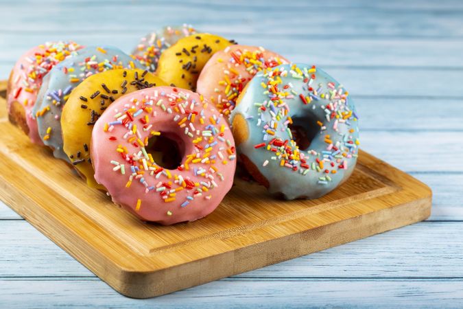 Delicious assorted colorful donuts on the table.